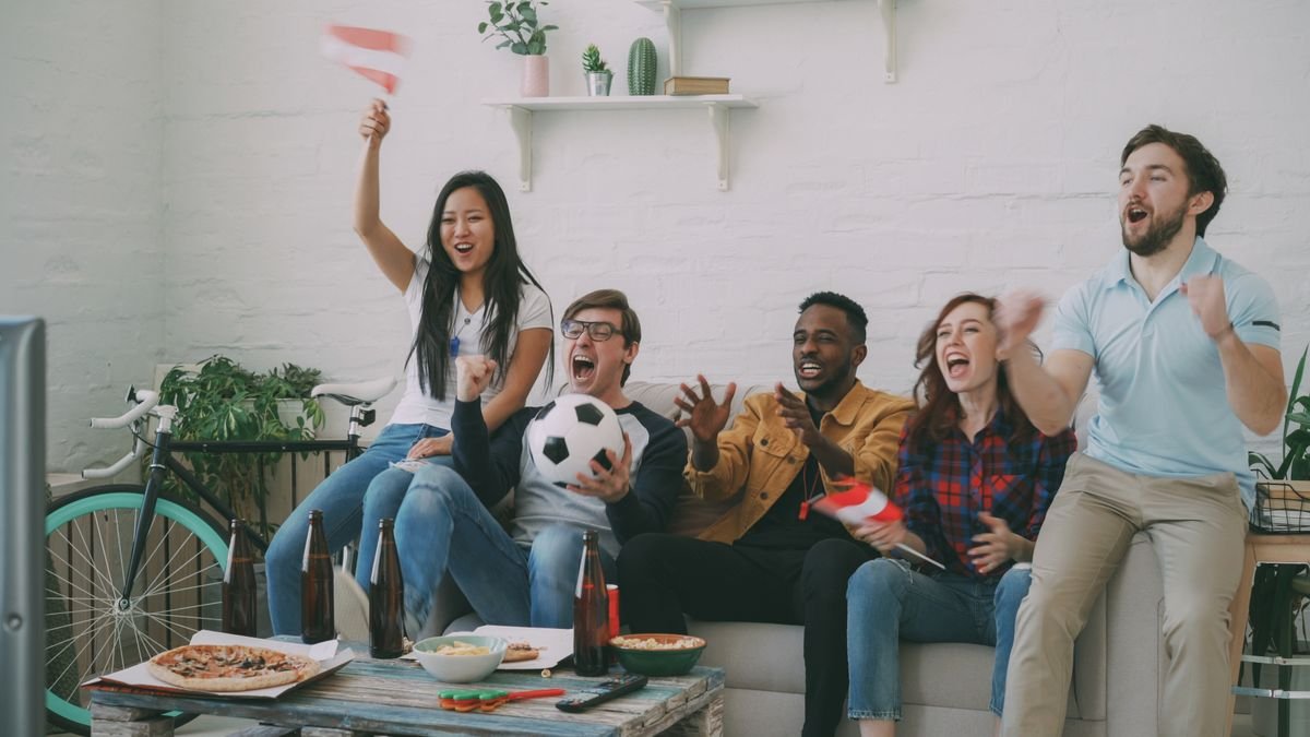 Friends watching the best IPTV UK for Premier League matches together